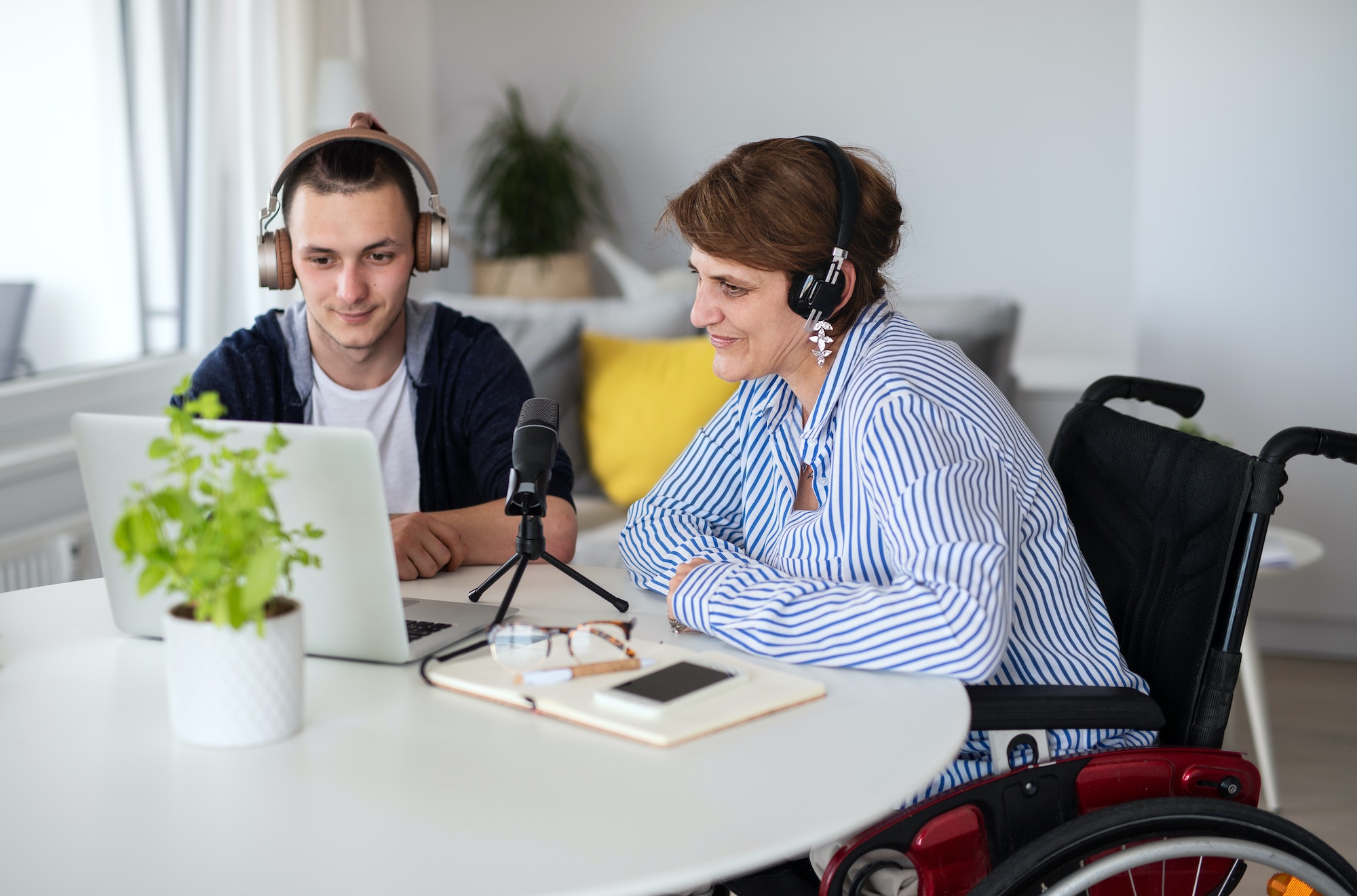 disabled-people-sitting-at-the-table-indoors-at-home-recording-podcast-at-home.jpg